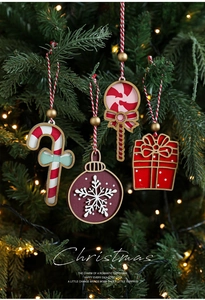 Detailed close-up of red and white wooden Christmas ornaments on a lighted pine tree