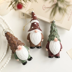 Three-piece Christmas gnome ornaments featuring pinecone and tree hats on a decorative tray