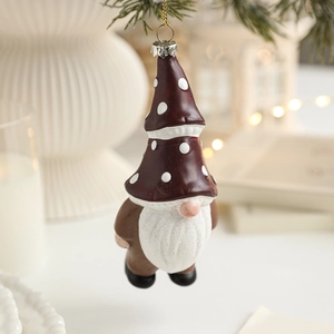 Nordic Gnome Christmas tree ornament with red polka dot hat on festive pine branch