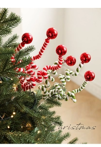 Close-up of red foam candy balls and spiral striped chenille stems on Christmas tree