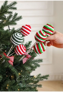 Detail of red and green swirl foam candy cane picks with bows on a Christmas tree
