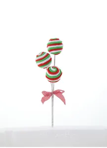 Detail view of plush Christmas lollipop pick with red green stripes and checkered bow tie