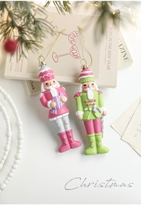 Close-up of colorful soldier nutcracker ornaments with gold strings for Christmas trees