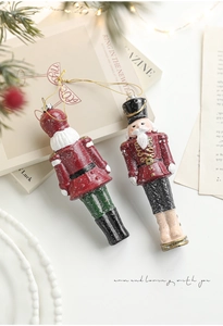 Macro detail of nutcracker Christmas ornaments with snow texture and gold string