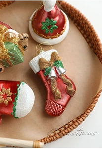 Detail of Christmas hanging ornaments with red pearl finish and glitter on tray