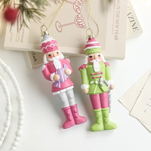 Pink and green soldier nutcracker Christmas tree ornaments with gold hanging strings