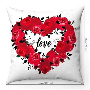 Detail of red rose heart wreath and black love script on white plush pillowcase