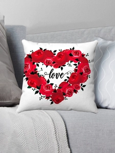 Detailed view of plush pillow cover featuring red rose heart and love script on sofa