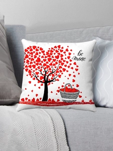 Detail of a white Valentine cushion cover with a red heart tree and be mine text on a sofa