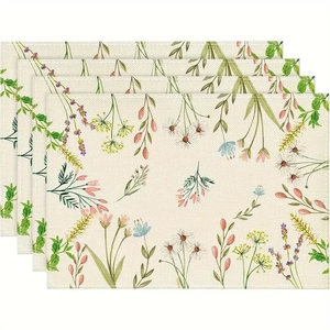 Détail de quatre sets de table en lin résistants à la chaleur avec motifs floraux colorés