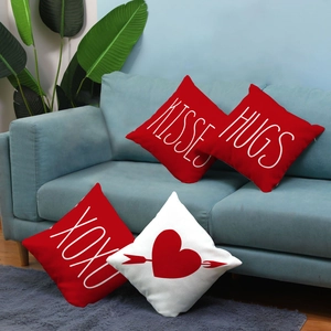 Detail of four Valentine plush pillow covers with KISSES HUGS and XOXO prints