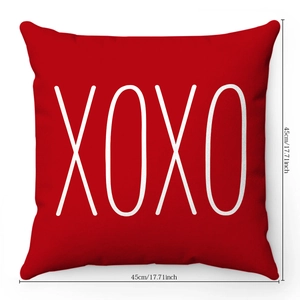 Detail of red plush pillow case with white XOXO heart design and 45x45cm size marking