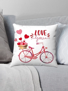 Detail of white plush pillowcase with red bicycle and heart balloons on grey sofa