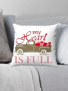 Detail of white plush pillowcase featuring a vintage truck and heart design on a sofa