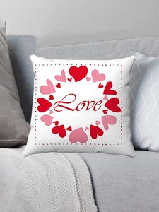 Detail of soft plush pillowcase featuring a red heart Love print on a grey sofa