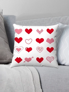 Detail view of white plush pillowcase with 16 red heart prints on a gray sofa