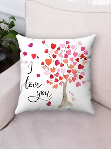 Detail of plush pillowcase with watercolor heart tree and I love you print on sofa
