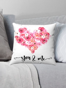Detail of flamingo plush pillowcase with heart rose pattern on a grey sofa