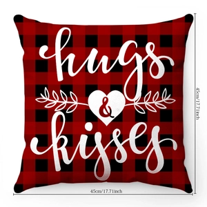 Close-up of red and black buffalo plaid cushion cover with white hugs and kisses print