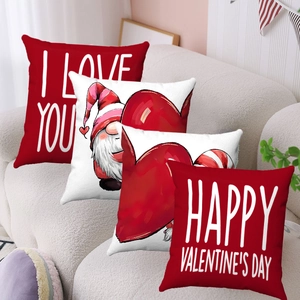 Detail of red heart and gnome pattern plush pillow covers on a cozy sofa setting