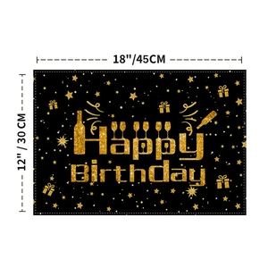 Black and gold Happy Birthday table mat with festive balloon and gift box patterns