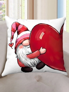 Detail of white plush pillowcase featuring a Valentine gnome holding a red heart on a sofa