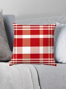 Close-up of red and white checkered throw pillow on a gray fabric sofa setup