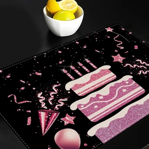 Detail of Happy Birthday place mat with pink glitter cake and balloons on black table