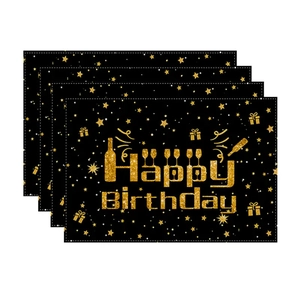 Detail of four Happy Birthday placemats with gold balloon prints on black background