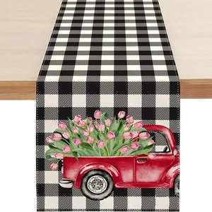 Détail d'un chemin de table en lin à carreaux noir et blanc avec camion rouge et tulipes