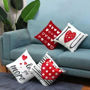 Detail of four short plush Valentine's Day pillow covers on a cozy sofa