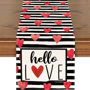 Détail du chemin de table en lin à rayures noires et blanches avec cœurs rouges et texte hello LOVE