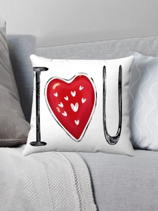 Detail of soft plush white pillow cover with I Love U heart print on a grey sofa