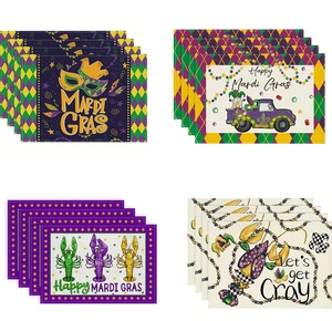 Set of four Mardi Gras themed placemats with festive masks and crawfish patterns