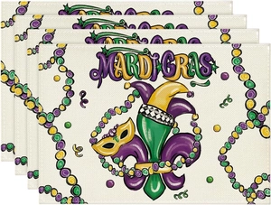 Detailed texture of Mardi Gras placemats featuring fleur-de-lis and mask print