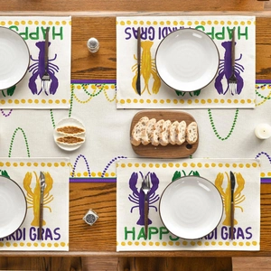 Mardi Gras table runner and placemat set with lobster design on dark wooden table