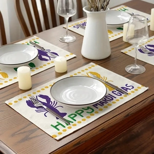 Detail of linen Mardi Gras placemat set with crawfish design on dark wooden dining table