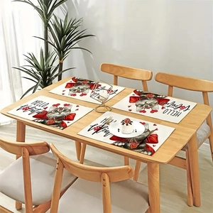 Set of four linen Valentine's placemats featuring heart cat prints on a wooden table