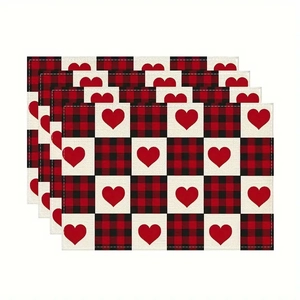 Detail of 4-piece linen placemat set with red buffalo plaid and heart print patterns
