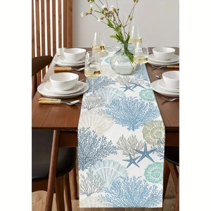 Blue coral and starfish linen table runner with beach ocean patterns on wooden dining table