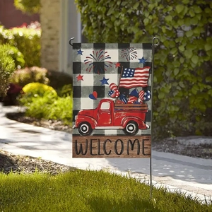 Detailed view of Independence Day garden flag with red truck and American flag on grass