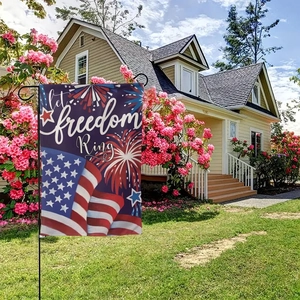 Outdoor garden flag with Independence Day stars and Let Freedom Ring quote on metal stand