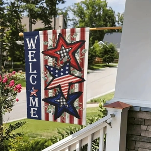 Close-up of Welcome garden flag with stars and stripes hanging on a porch pole