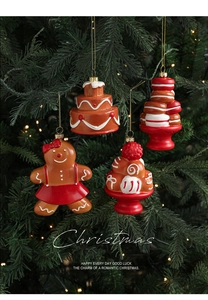 Detailed view of gingerbread girl and dessert ornaments hanging on a Christmas tree