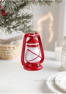 Detalle de un farol vintage rojo y blanco colgado en un árbol de Navidad festivo
