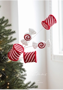 Close-up of glittered red and white candy cane picks on a decorated Christmas tree