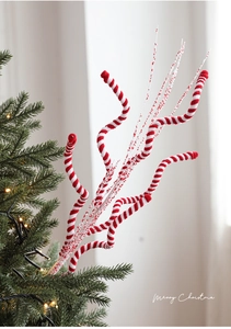 Macro detail of red and white striped spiral branch picks for Christmas tree decor