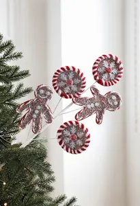 Macro view of gingerbread man and mint candy picks with sugar texture for Christmas tree