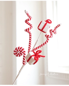 Detail of Christmas tree pick with red and white spiral stems and glitter gift boxes