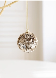 Detail of champagne gold sequin tassel Christmas ball ornament with embossed metallic cap